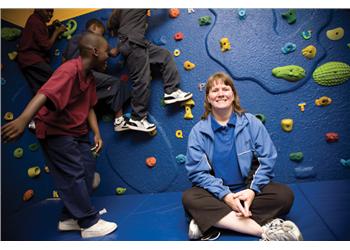 kids climbing on an indoor rock wall