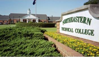 college entrance sign with landscaped garden