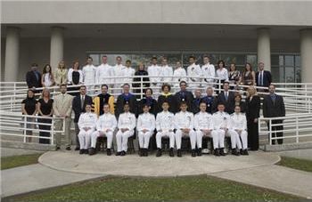 group of people in formal wear posed on steps