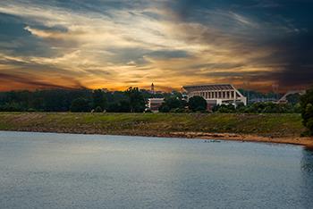 sunset view over water with university stadium in background