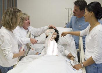 nursing students practicing on a medical mannequin