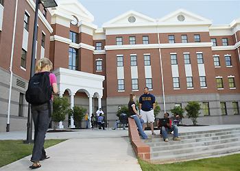 students and faculty outside a campus building