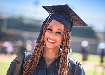 smiling graduate in cap and gown