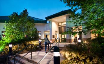 lit campus building entrance at dusk