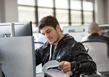 male student reading study materials