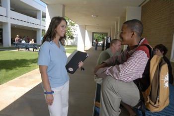 students conversing in a campus walkway