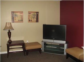 living room with a tv and two lamps