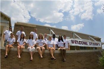 students on steps with 'welcome students' banner