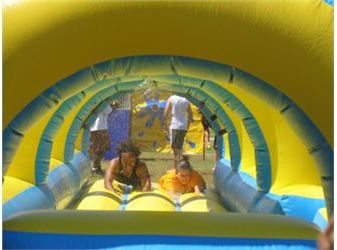 children playing on a colorful inflatable slide