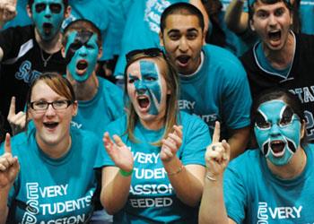 students in blue excited at event