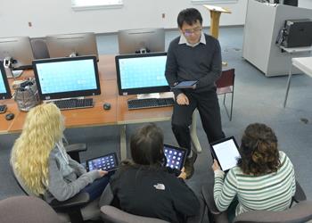 instructor teaching students with tablets