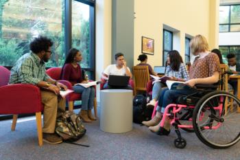 students seated in a circle in a library setting