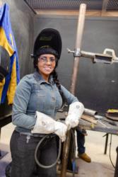 woman in welding gear at work station