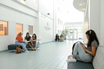 students studying in a bright campus hallway