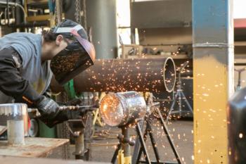 student welding in a workshop