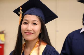 graduate smiling with honor cords