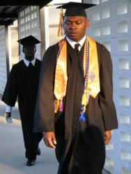 graduate walking in cap and gown