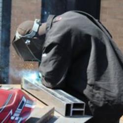 student welding in workshop