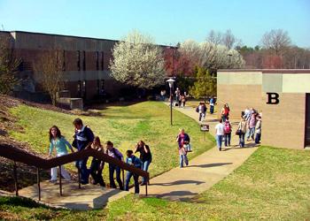 students walking on a college campus on a sunny day